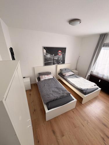 a bedroom with two beds and a tv on the wall at Wohnung in herzogenrath-strass für max 4 Gäste in Herzogenrath
