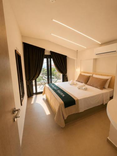 a bedroom with a large bed and a window at Sea Salt Maisonettes Samos in Ireon