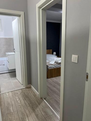 a bedroom with a bed and a door leading into a room at Achim-House in Beiuş