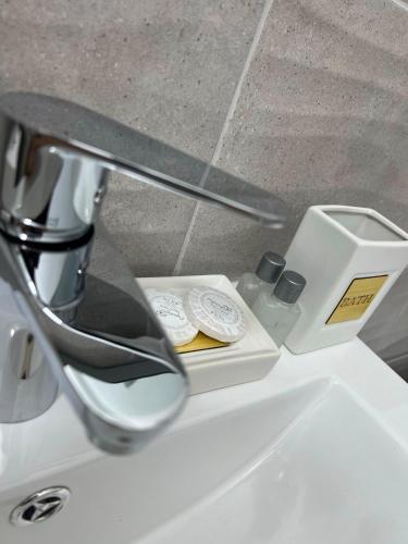 a bathroom sink with a mirror next to a counter top at Achim-House in Beiuş
