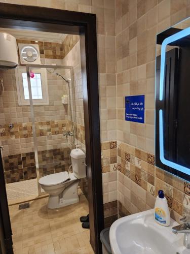a bathroom with a toilet and a sink at قصر الهدوء in Jeddah