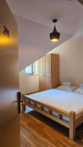 a bedroom with a large bed in a room at Tang Guesthouse in Medvode