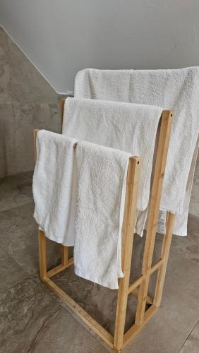 a towel rack with two white towels on it at Tang Guesthouse in Medvode