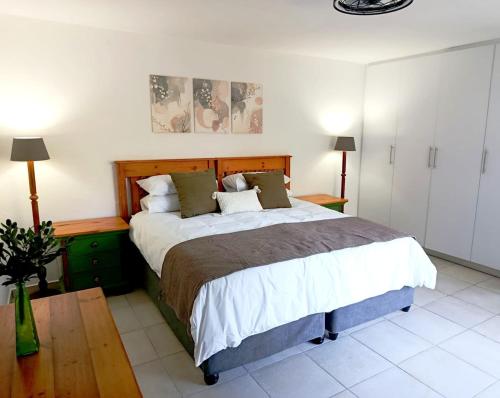 a bedroom with a large bed in a room at The Tee Box in Southbroom