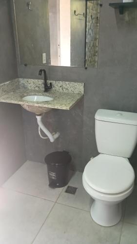 a bathroom with a white toilet and a sink at Cantinho,RMA in Bom Jesus dos Perdões