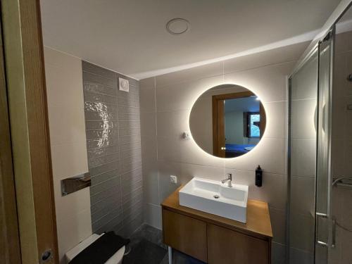a bathroom with a sink and a mirror at Risoturismo-Solar de São João - Guest House - in Almeida