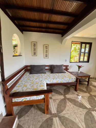 a bedroom with a large bed in a room at Casa de Marina in Palmeiras