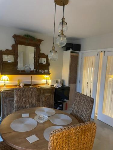 a dining room table with two chairs and a table with at Belle-Vue in Truro