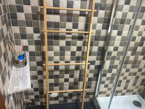 a shower with a wooden ladder in a bathroom at Charming Casa Azul - Stay in Historic Chaves in Chaves