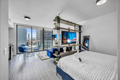 a bedroom with a bed and a living room with a tv at The Sanctuary King studio in Miami