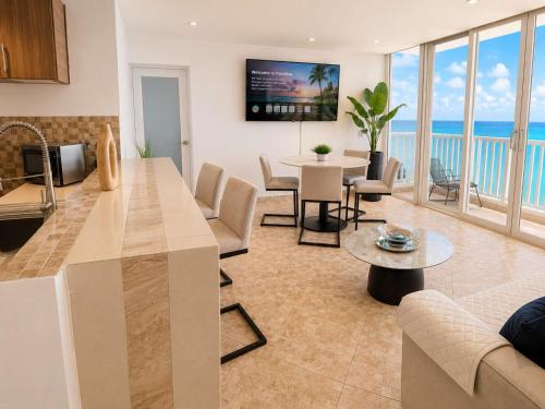 a kitchen and living room with a view of the ocean at Beachfront Stella Maris Apt on Condado Ave in San Juan