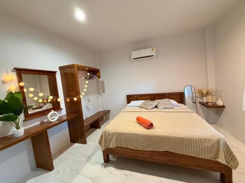 a bedroom with a bed and a mirror at Diamond House in Srithanu in Srithanu