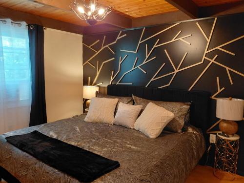a bedroom with a bed with a black wall at LAKEFRONT CHALET in THE BURCHES in Tobyhanna
