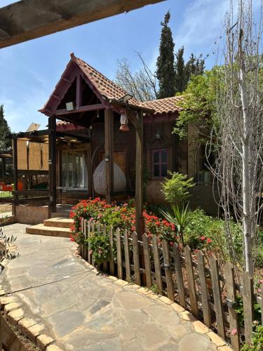 a small house with flowers in front of it at Fashet alsalt-فشة السلط in Al Salt