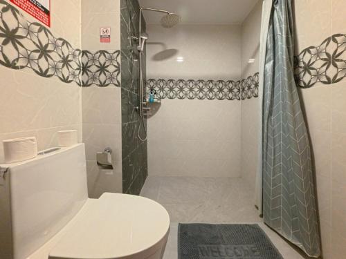 a bathroom with a toilet and a shower at Rihiveli Residence Thoddoo in Thoddoo
