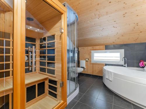 a bathroom with a tub and a shower and a toilet at Bärenschanze in Hohentauern