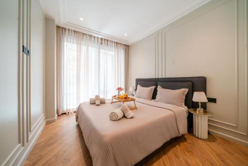 a bedroom with a large bed with a table on it at VIVASTAY Casablanca -Corniche Le claridge Emerauld with gym and rooftop in Casablanca