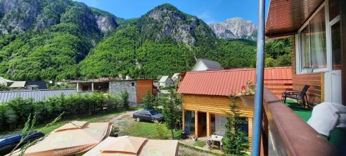 a view of a house with mountains in the background at Mikel Center Theth Guesthouse in Shkodër