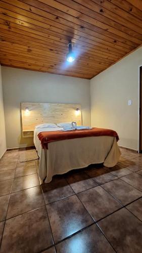a bed in a room with a wooden ceiling at Mariposa 88 in Puerto Rico