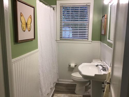 a bathroom with a white toilet and a sink at Cute 2 bedroom house in Augusta in Augusta