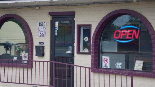 an open sign in the window of a store at Relax Inn in Flagstaff