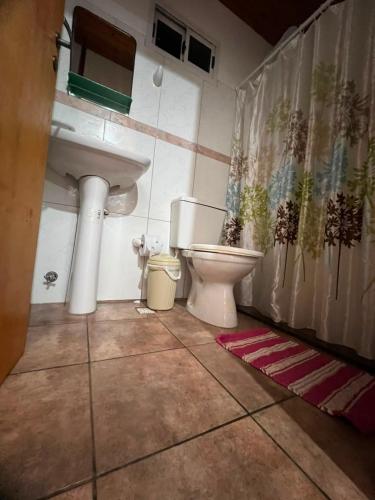 a bathroom with a toilet and a sink at Mariposa 88 in Puerto Rico