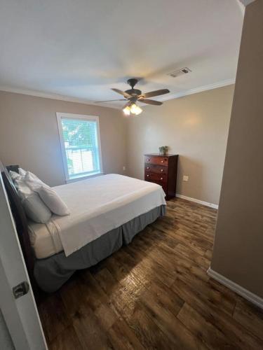 a bedroom with a bed and a ceiling fan at Red Leaf Cottages in Lake Village