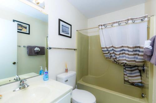 a bathroom with a sink and a toilet and a shower at Pool Days & Water Fun Await: Lake Ozark Escape! in Lake Ozark