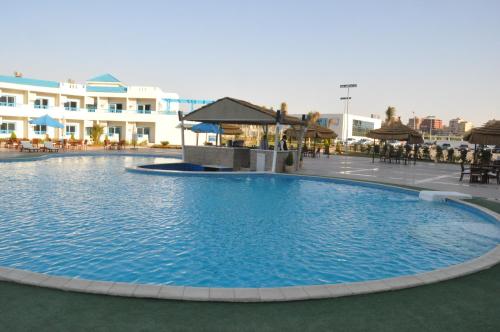 a large swimming pool in front of a hotel at The Guard Hotel in Cairo