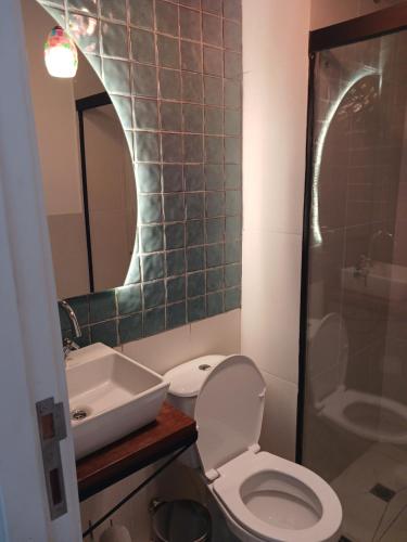 a bathroom with a toilet and a sink and a shower at Departamento en Condominio in Luque