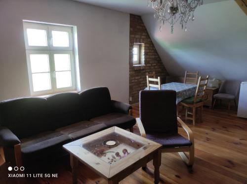a living room with a couch and a table at Storchenhorst 