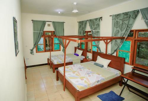 a bedroom with two bunk beds and a piano at Panofu Homestay in Moshi