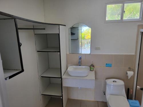 a small bathroom with a sink and a toilet at Ocean View in Big Corn Island