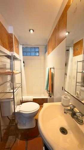 a bathroom with a toilet and a sink at Club Colonial Hotel in Huanchaco