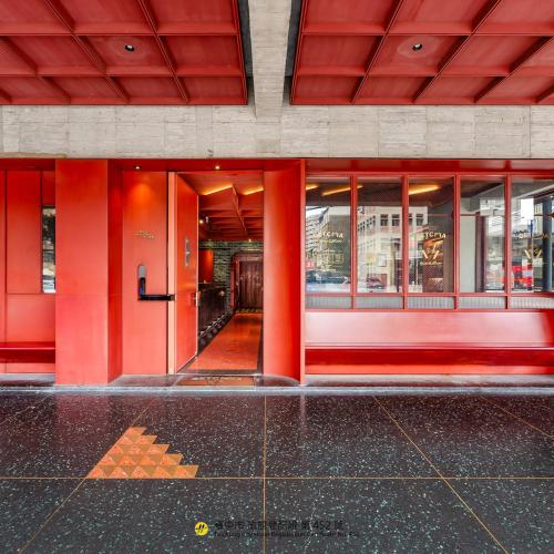 an entrance to a building with red columns at Getcha Hostel in Taichung