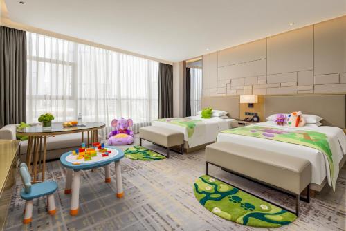 a childrens bedroom with two beds and a table at Chengdu Marriott Hotel Financial Centre in Chengdu