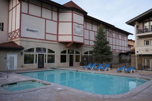 a hotel with a swimming pool in front of a building at Zermatt Mountain Suite and 1BDR in Midway