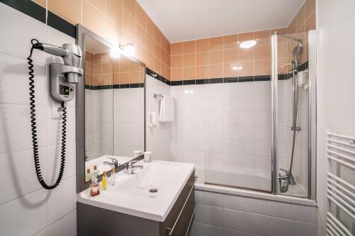 a bathroom with a sink and a shower at Comfort Aparthotel Lourdes Lorda in Lourdes