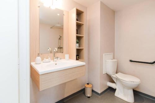a bathroom with a sink and a toilet at Quality Aparthotel St-Berthevin Laval in Saint-Berthevin-sur-Vicoin