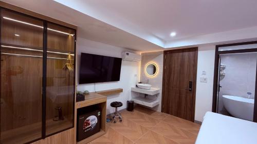 a bathroom with a television and a sink and a toilet at Sky Hotel in Ninh Binh