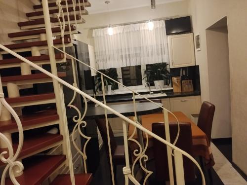 a kitchen with a spiral staircase and a dining room at Дом in Odesa