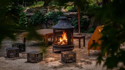 a fire burns in front of a table and a fireplace at Gapyeong ebenzer Pension in Gapyeong