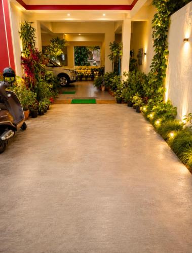 a hallway with plants and a car in a building at The two bedroom house in Madikeri