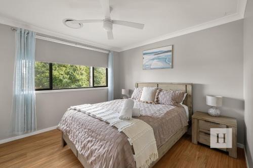 a bedroom with a bed and a large window at Sunrise Waters in Gorokan