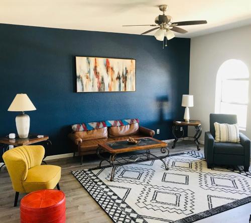 a living room with a couch and chairs at The Tortolita House in Tucson