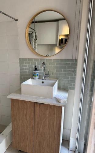 a bathroom with a sink and a mirror at The Lakeside Retreat in Perth