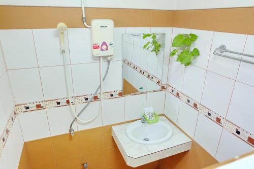 a bathroom with a sink and a shower at Siam House Interplace in Lop Buri