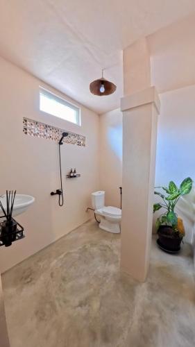 a bathroom with a toilet and a sink at Alianna Homestay in Karimunjawa