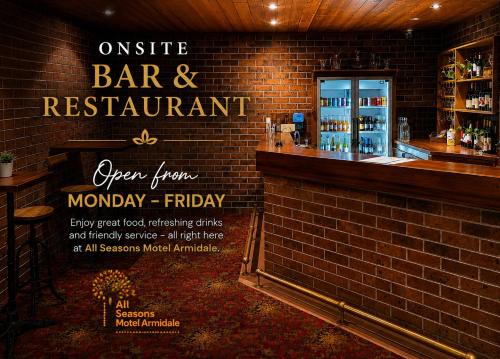 a bar and restaurant with a brick wall at All Seasons Motel Armidale in Armidale