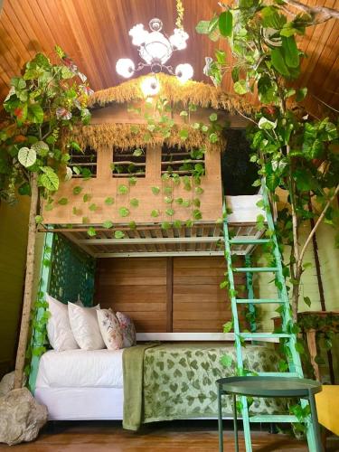 a bunk bed in a room with a tree at Bleu Verde, The Self Healing Hotel & Retreat in Gili Trawangan